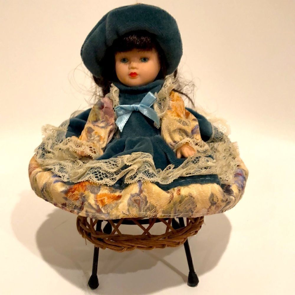 Porcelain doll 7.5” with wicker chair